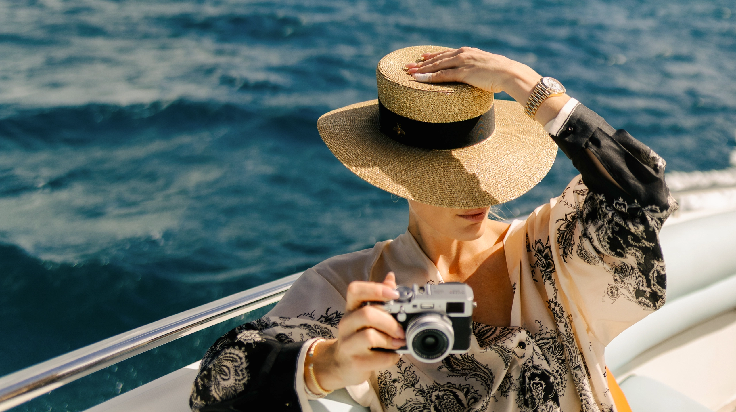 Woman holding a camera on a private yatch